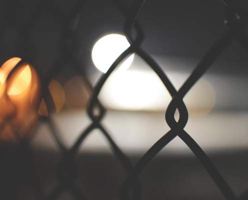 Fence with lights in the background